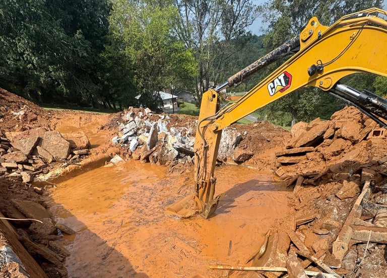 excavator digging out concrete pool