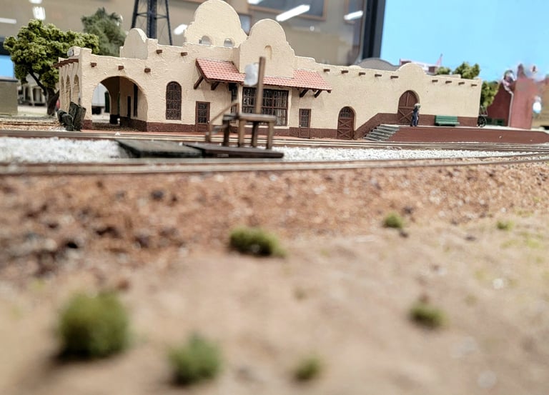 Gilbert Train Station in Gilbert, Arizona. Tan stucco building with curved arches along the roof.