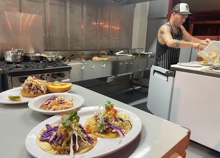 Fresh tacos, pulled pork sandwich and cole slaw. Barrel Bar & Grill restaurant kitchen.