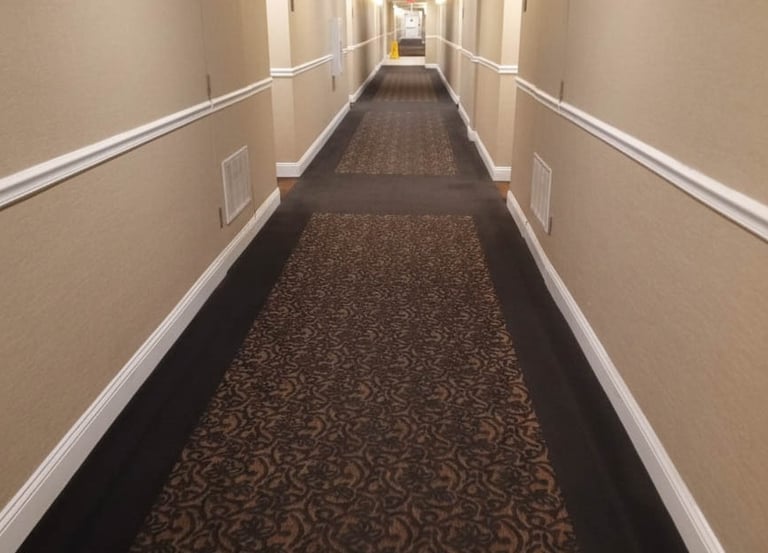 Professional deep steam cleaning results on a high-traffic hotel hallway carpet in Cumberland, RI, p