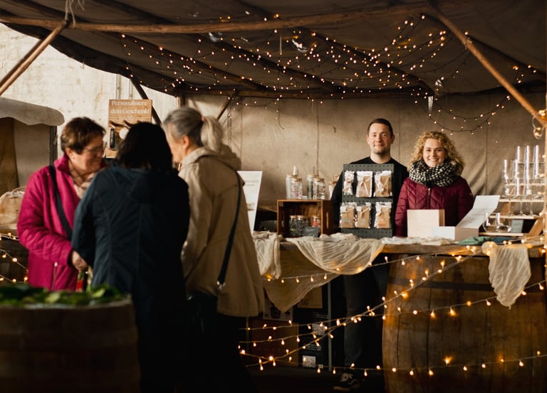a group of people standing around a table with wine glasses