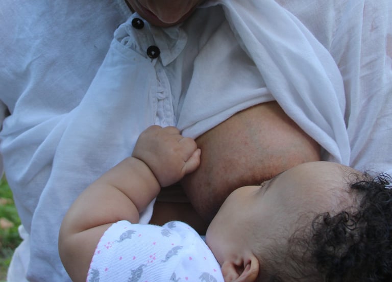 Iveth nursing her daughter