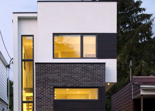 a house with a large window and a small patio
