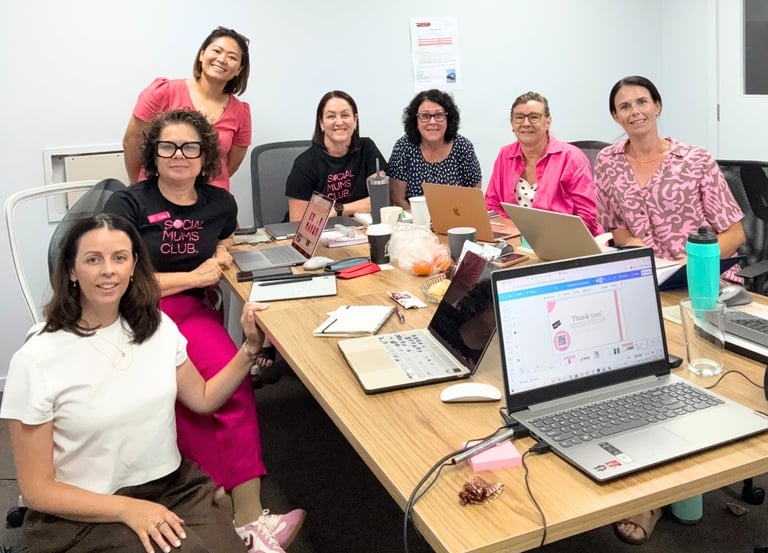 Group of small business owners participating in a beginner-friendly digital workshop with laptops an