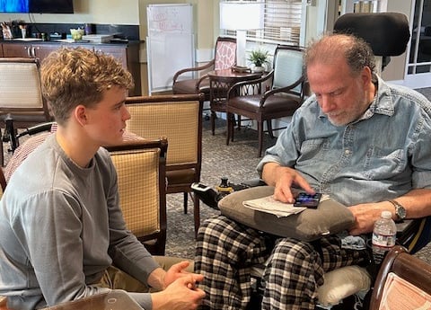 Teens Who Tech helping an elderly man feel more comfortable with technology