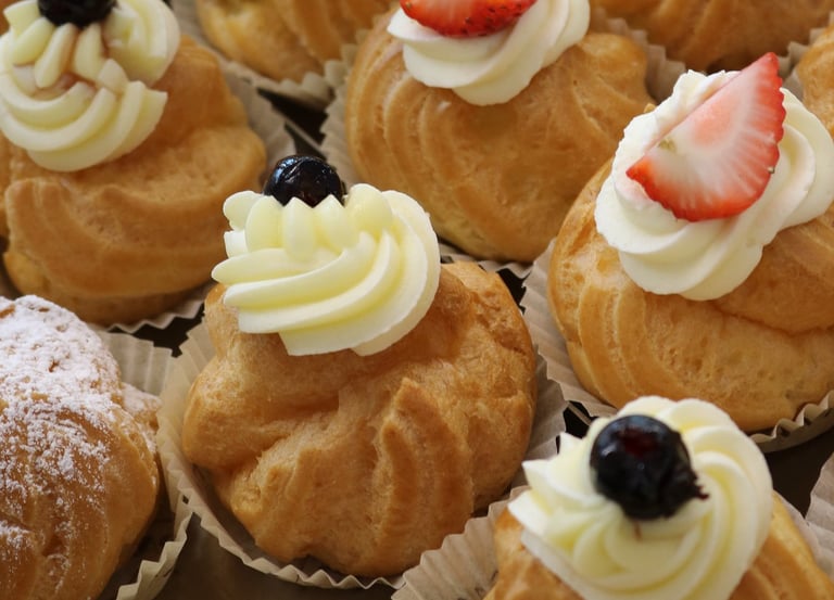 a variety of pastries on display in a bakery