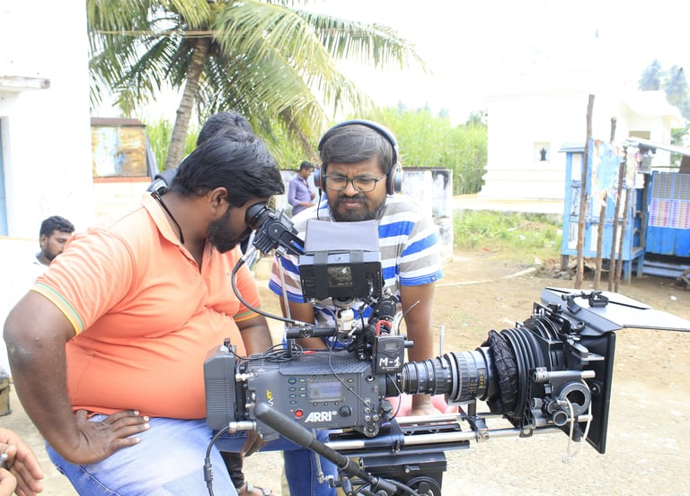 Director and camera man reviewing footage on a corporate film set.