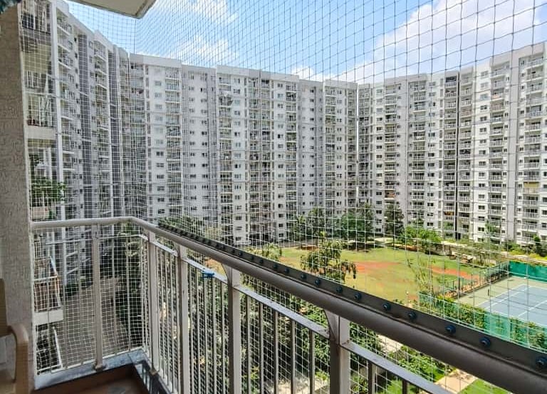 A close-up photo of a securely installed balcony safety net on a residential building in T Nagar.