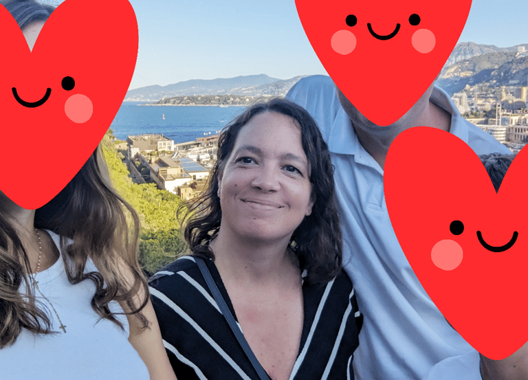 a group of people standing around a group of red hearts