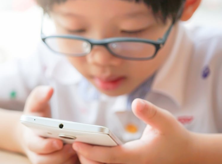child reading letters in phone