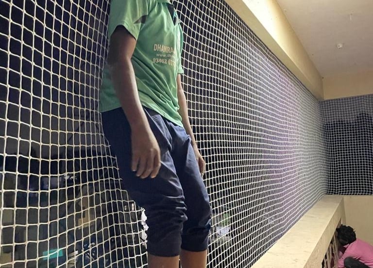 A bright, secure balcony fitted with child safety nets in a Koramangala apartment.