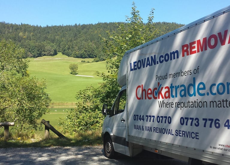 a removal truck with parked in front of a park in surrey