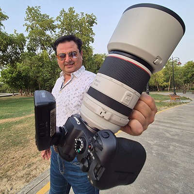 a man holding a camera and a camera