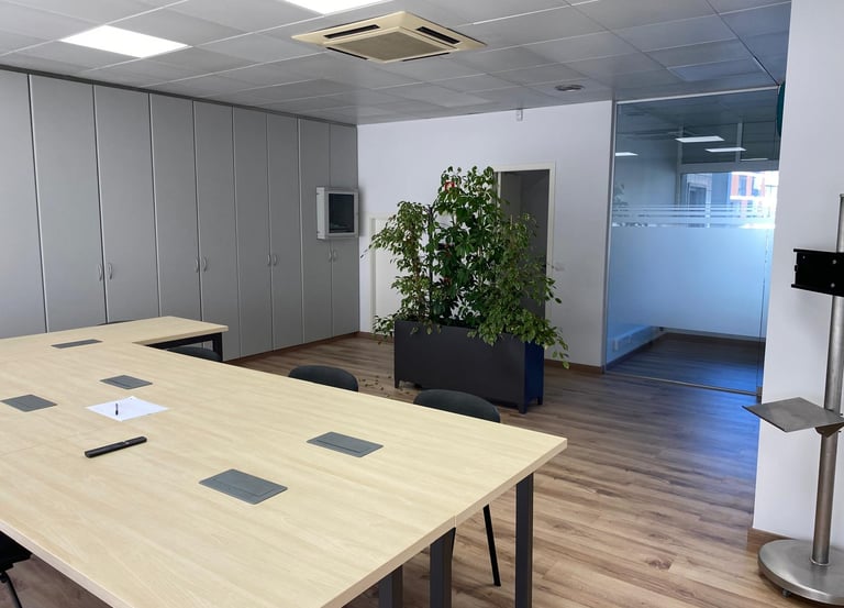 a table with a plant in a room with a plant in the middle