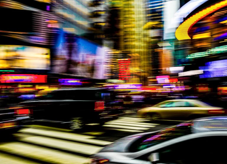 a city street scene with a car driving down the street