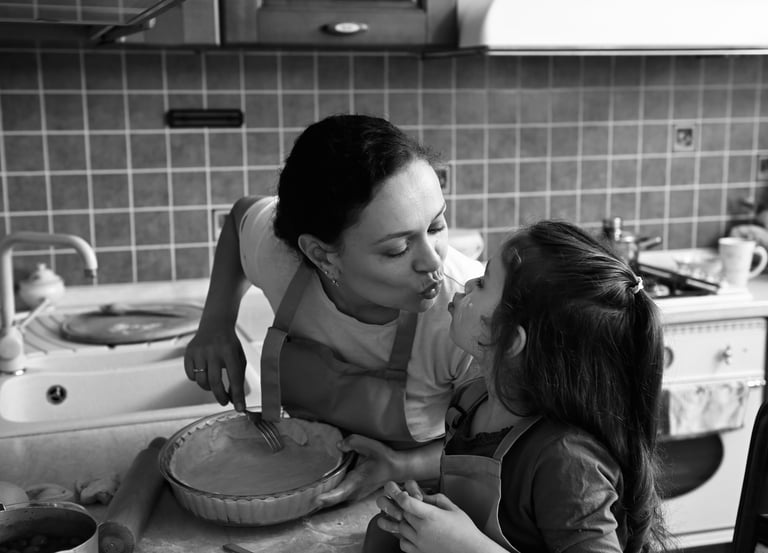 a hispanic woman and her daughter are in the kitchen