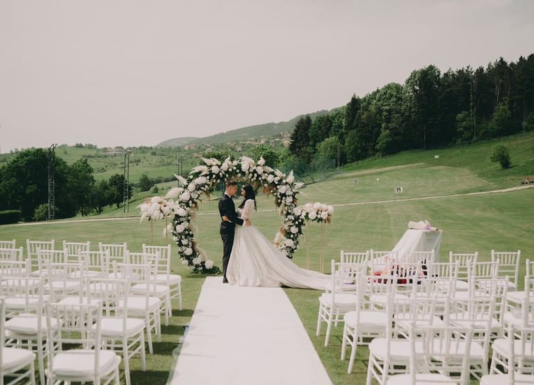a bride and groom standing in front of a wedding ceremony