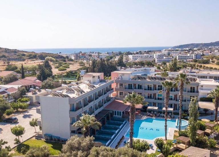 Aerial view of Dias Hotel in Crete featuring a swimming pool and sun deck with a coastal backdrop.
