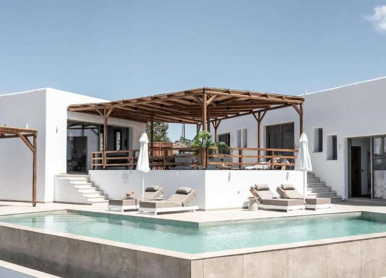 Luxury white modern villa with a private swimming pool and wooden pergola lounge area.