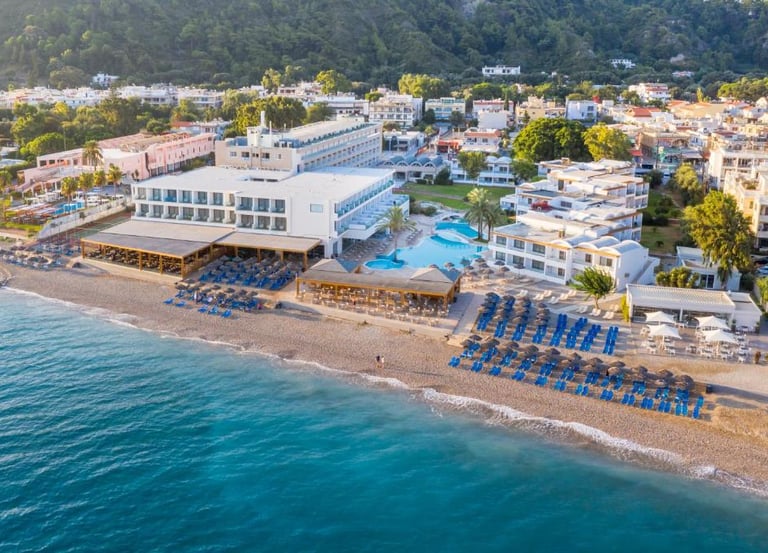 Aerial view of a luxury beachfront resort in Rhodes with a private pool and turquoise sea.