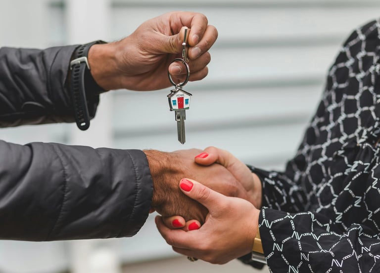 Key handover between two people representing mortgage approval and homeownership
