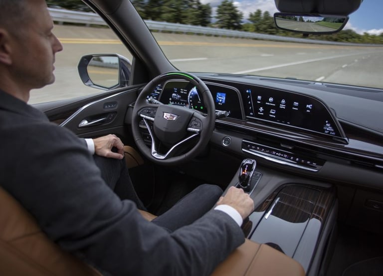 a man in a suit and tie is driving a car