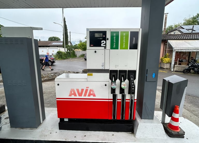 An Avia gas station fuel pump with unleaded and diesel dispensers under a canopy.