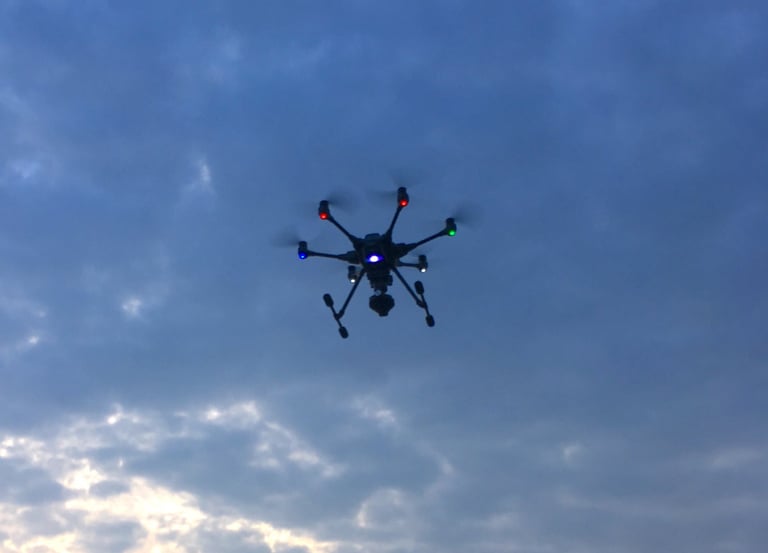 a small drone flying through the sky