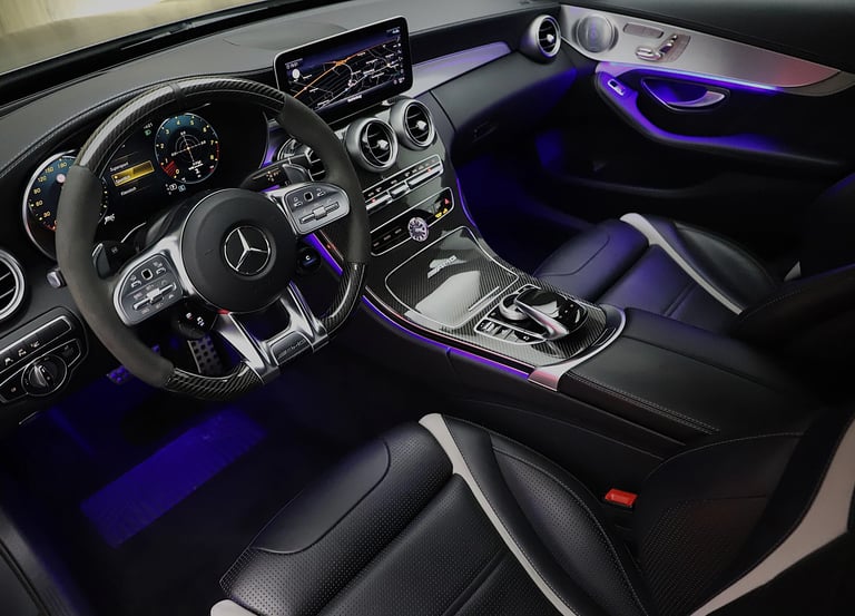 a car dashboard with a steering wheel and dashboard lights