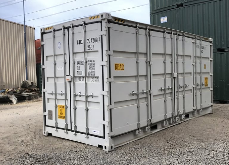 White steel side-opening shipping container with multiple doors for easy loading access in a gravel yard.