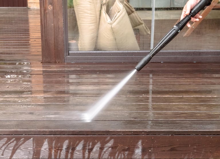 Pressure washing deck before exterior painting
