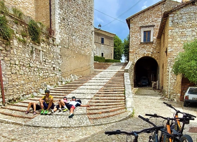 bicycles parked in front of a stone building