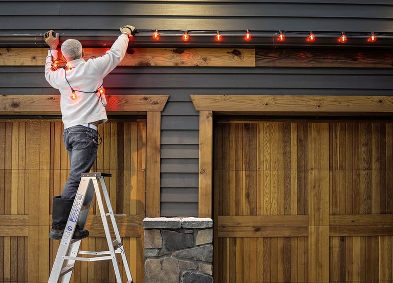 Installer taking down Christmas lights along a home roofline