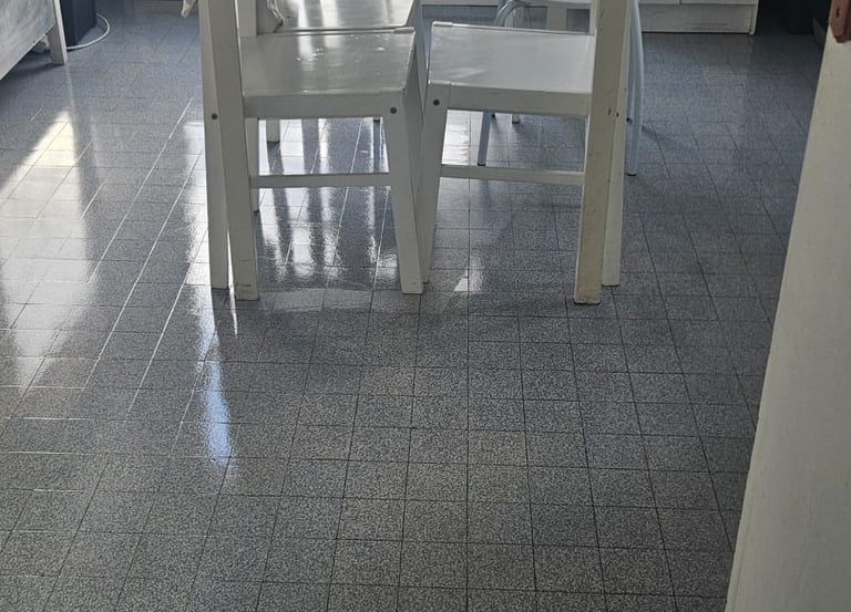 a kitchen with a table and chairs in the middle of the room