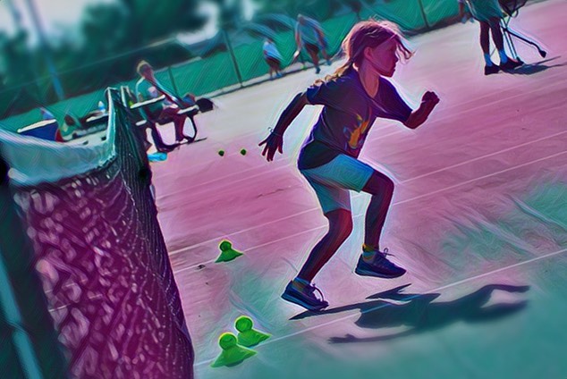 Little girl running on tennis court doing drill at tennis camp in Panama City Beach, FL.