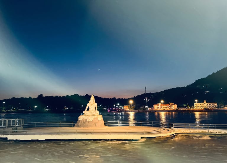 Lord Shiva statue on a pier at Parmarth Ashram in Rishikesh, overlooking the Ganges River