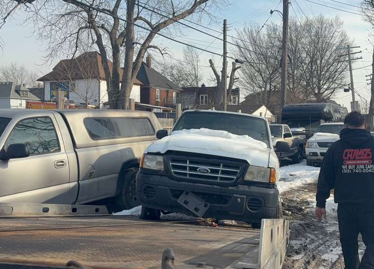 Tow truck picking up a junk car in Detroit