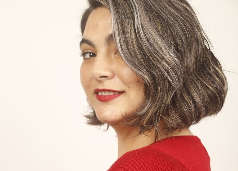 a woman with a red sweater and red lipstick