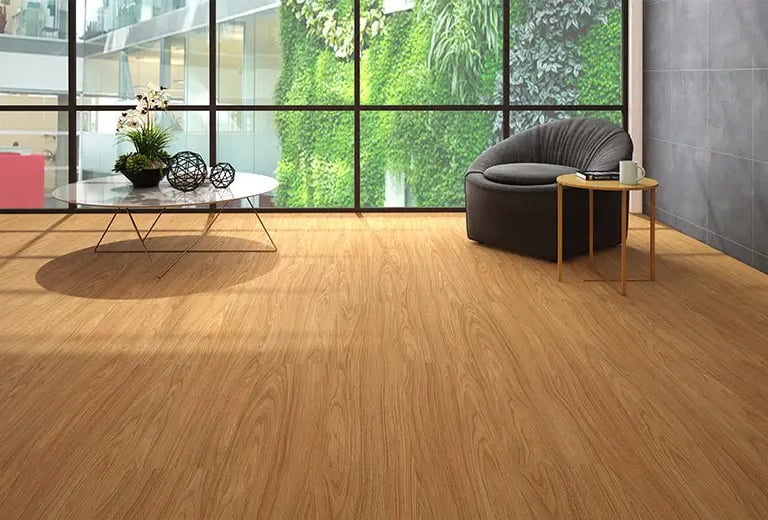 a wooden flooring living room with a chair and a table