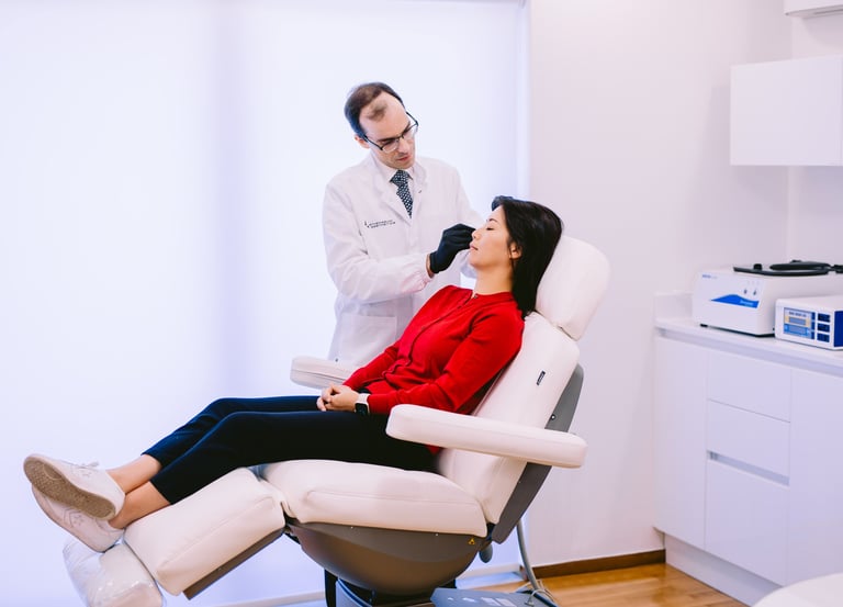 Dr Matthaios Souchlakis assessing a patient during consultation at Athenaeum Aesthetics