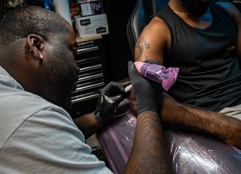 Andre doing a floral cover up tattoo