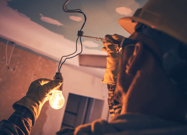 A licensed electrician in Comanche Tx testing the power with a volt meter at a remodel