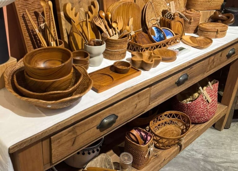 Wooden kitchenware and woven rattan baskets displayed on a vintage wood table.