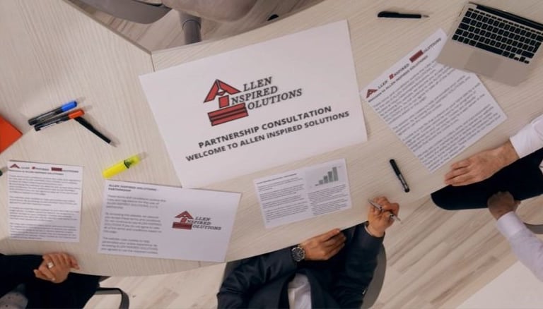 a group of people sitting around a table with AiS partnership papers
