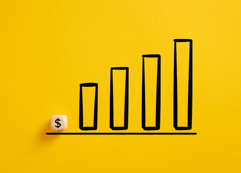 Dollar symbol on a wooden cube with an ascending graph