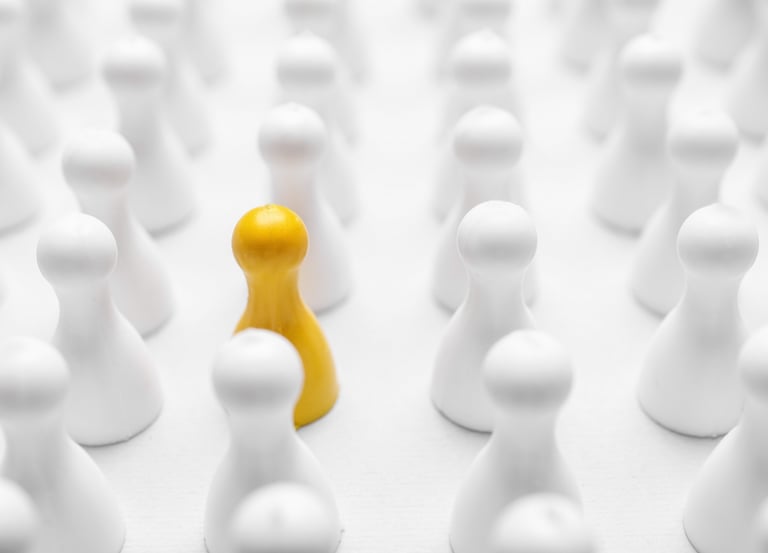 Closeup of yellow pawn among others on white background