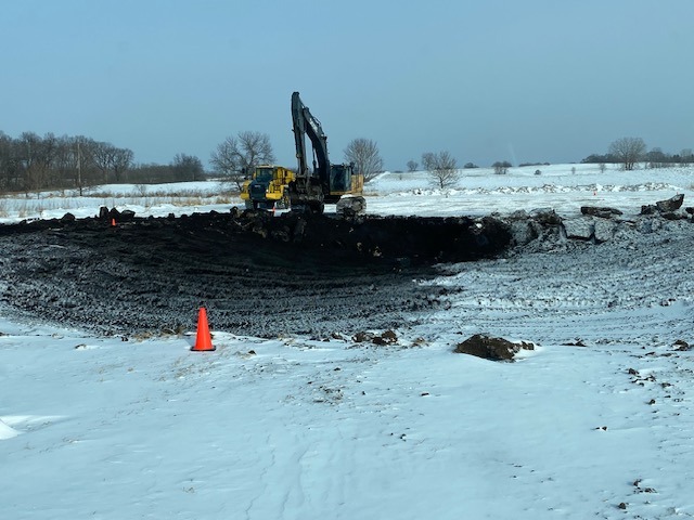 pond being excavated in the snow