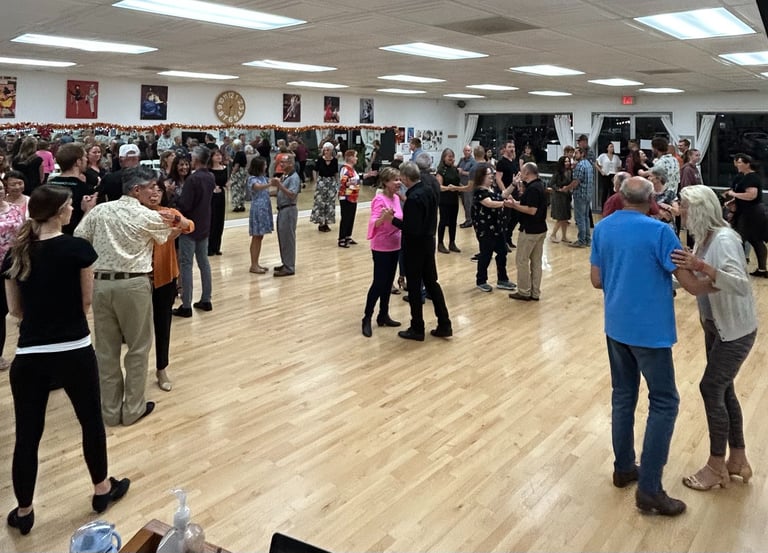 smiling dancers attend a social event at mccann dance learning a ballroom dance.