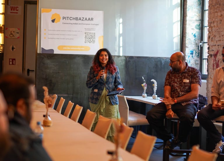 Shruti the founder, moderating the Pitchbazaar event with a mic in her hand.