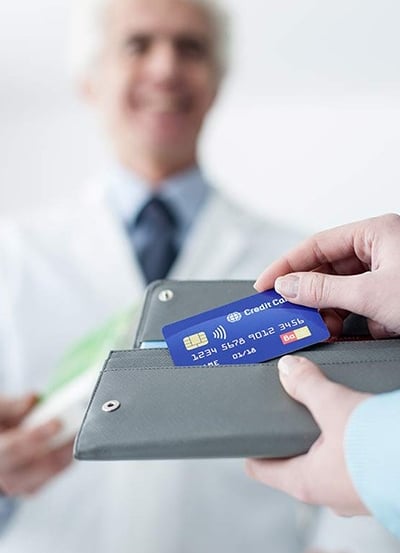 a doctor holding a credit card